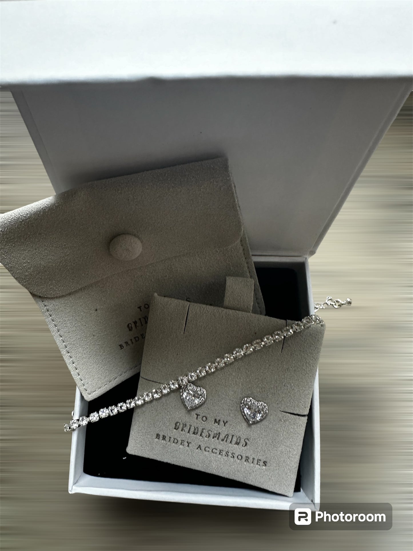 Silver tennis bracelet and heart shaped earrings