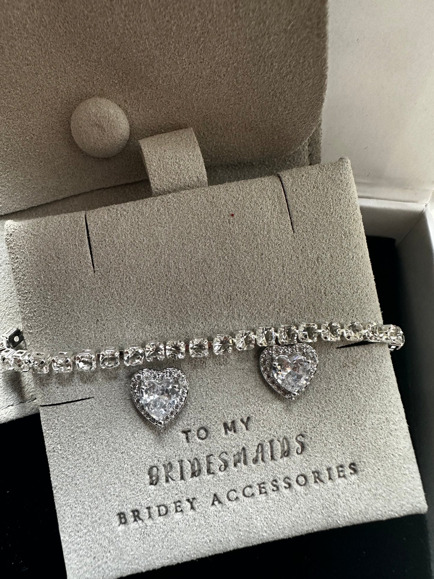 Silver tennis bracelet and heart shaped earrings