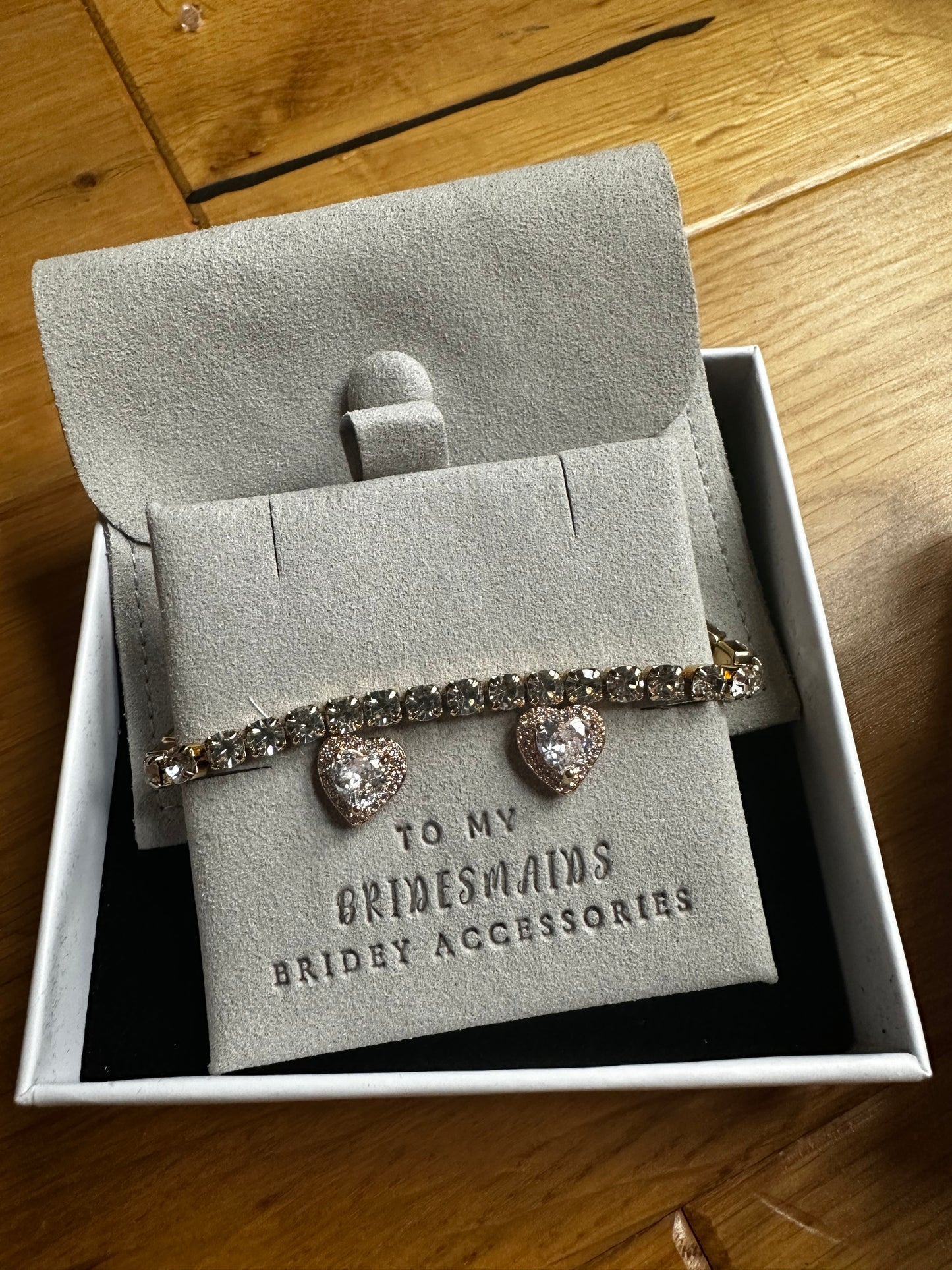 Gold tennis bracelet and heart shaped earrings